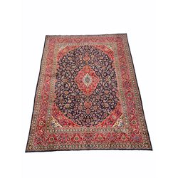 Fine hand Knotted Persian Kashan red and blue ground carpet, the busy central field decorated with interlaced foliate 400cm x 295cm