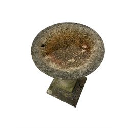 Reconstituted bird bath raised on a square stepped base 