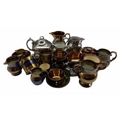 Collection of 19th century English lustre pottery including four jugs with blue bands on a copper ground, various other copper and silver jugs, cups and bowls etc (24)