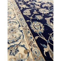 Persian Nain design ground rug, the blue field with floral medallion on blue field with interlaced trailing foliate, bordered and signed 205cm x 124cm