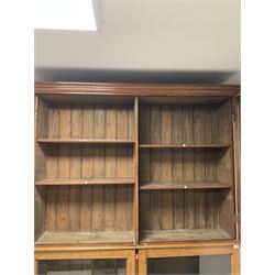 19th century mahogany library bookcase, the projecting cornice over four glazed doors, opening to reveal ten adjustable shelves, raised on a plinth base