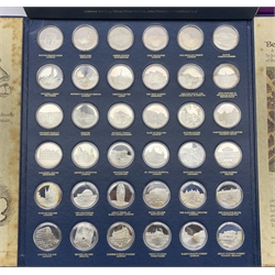 'Betjeman's Bygone Britain', a collection of thirty-six hallmarked sterling silver medallions by John Pinches from a strictly limited edition issue of 1266, depicting landmarks which have vanished from the face of Britain as selected by Sir John Betjeman, housed in a bespoke presentation folder and outer cover, with certificates and information leaflets, together with an additional 'Chain Pier, Brighton' medallion housed in a unopened card folder, each medallion weighs 33.5 grams