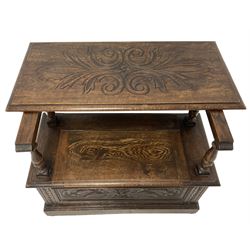 Carolean design oak monks bench or settle, hinged metaphoric table back carved with foliate decoration with central lozenge, turned supports over hinged box seat compartment, the panelled front carved and moulded with Green Man and extending foliage