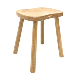 'Mouseman' Yorkshire oak four leg stool, with adzed saddle seat raised on octagonal tapered supports, W37cm, H46cm
