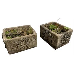 Pair of weathered cast stone rectangular planters, with floral relief decoration