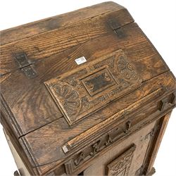 17th century oak bible box on cupboard, hinged sloped top with moulded edge, decorated with applied central panel carved with floral lunettes, frieze decorated with applied lettering, over the single cupboard door with matching panel, on moulded skirted base