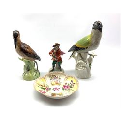 German Porcelain figure of a woodpecker H23cm, Rudolstadt bird with reeds H20cm, Volkstedt monkey musician and a saucer dish 
