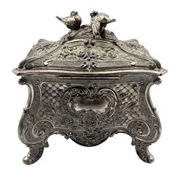 Early 20th century WMF silver-plated Britannia metal casket, of bombe form cast in relief with flowers and scrollwork, silk lined interior, dove finial and four scroll supports, L13cm