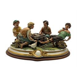 Large Capodimonte group 'The Card Players' by Luciano Cazzola, on oval plinth, L 50cm