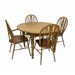 Light oak dining table, the circular top raised on turned supports (D124cm, H76cm) together with with set four (2+2) elm and beech Windsor style dining chairs (W60cm)