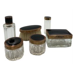 Art Deco five-piece silver-gilt and black enamel dressing table set by G H James & Co, London 1926, comprising two circular and one rectangular cut glass jars, scent bottle, cylindrical jar and oval brush