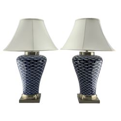 Pair of large Chinese porcelain table lamps, each of inverted baluster form, decorated in the 'Myriad Fish' pattern against a blue ground, raised upon square brushed chrome base, H76cm including shade 