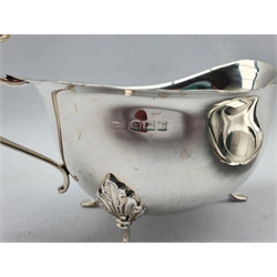 Georgian design silver sauce boat with crimped rim and scroll handle Birmingham 1929 and an oval stand of similar design W21cm Sheffield 1933 Maker Robert Stewart 12.5oz