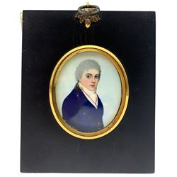 19th century oval portrait miniature, half length watercolour on ivory of a young gentleman wearing a blue coat and in ebonised frame 6.5cm x 5.5cm. This item has been registered for sale under Section 10 of the APHA Ivory Act