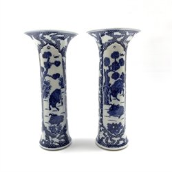 Pair of Chinese blue and white cylindrical vases, painted with Buffalo within moulded panels on a cell-ground reserved with butterflies with incised details, H28.5cm