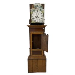 A late 19th century oak and mahogany longcase clock, with a swans neck pediment and break arch hood door, with ring turned pillars, oak trunk with canted corners, short oak door with mahogany inlay and a wavy top, on a rectangular pediment with cross banding and inlay, applied replacement painted dial with depictions of country scenes to the spandrels and break arch, Roman numerals, minute track and subsidiary seconds dial, dial inscribed “Kern, Swansea” with an eight day weight driven movement striking the hours on a bell. With pendulum.
