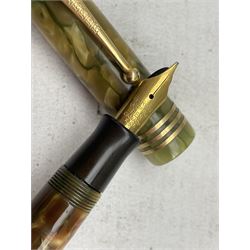 Parker, Duofold Lucky Curve, a green and brown marbled fountain pen, the cap with a gilt clip and triple cap band, button filling system and 18ct gold nib