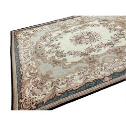 French Aubusson ivory ground carpet, the central floral bouquet medallion surrounded by a rose garland and a shaped foliate band with scrolling acanthus leaves and cartouche motifs, the border decorated with repeating rinceaux decoration, the corners with spayed acanthus leaves and scallop shell motifs, the exterior teal band with an outer egg and dart edge
Provenance: From the Estate of the late Dowager Lady St Oswald