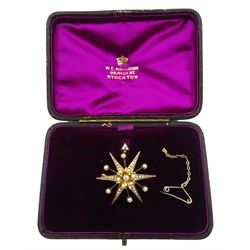 Early 20th century gold star brooch, set with a single diamond and split pearls, in purple velvet and silk lined box