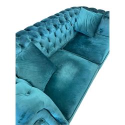 Chesterfield style two seat sofa, scrolled arms and uprights, upholstered in buttoned teal velvet, on turned tapering brass finish feet