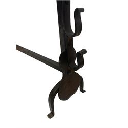 Pair of wrought iron fire dogs or andirons, cresset top over plain tapered stems mounted by spit rests and shaped plates, on curved out-splayed front feet