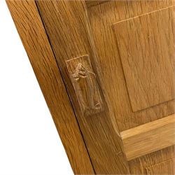 Fishman - adzed oak cupboard, hinged adzed top over panelled door, the handle carved with fish signature, the interior fitted with shelves, by Derek Slater, Crayke
