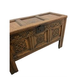 Early 19th century carved oak blanket box, the hinged three panelled lifting lid over carved base, raised on stile supports 
