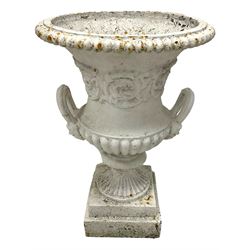 19th century Campana-shaped cast iron urn, lobed rim over scrolling acanthus leaf decoration to body, two looped handles with double masks, on fluted foot and stepped square base