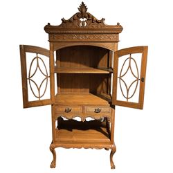 20th century oak display cabinet, shaped and pierced pediment carved with scrolled foliage, two glazed doors over two drawers and under tier, on ball and claw carved cabriole supports 