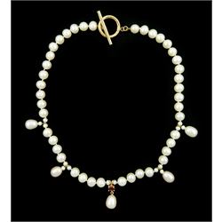 Single strand cultured pearl necklace, with suspending cultured pearl drops and a central cultured pearl and garnet pendant, with 14ct gold toggle clasp
