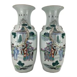 Pair of Chinese Republic porcelain vases, each decorated with figures and horses in a courtyard setting, twin lion mask ring handles, H57.5cm 