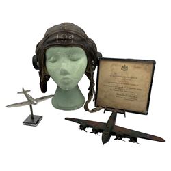 R.A.F. World War II flying helmet inscribed '194', Mention in Despatches certificate to Sergeant G.C.Mullings, Royal Air Force, published in the London Gazette 1st January 1945, wooden model of a WWII aircraft and a metal aeroplane model (4)