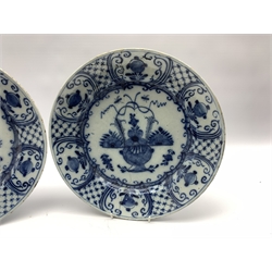 Pair of 18th century Delft blue and white chargers, centrally painted with a vase of flowers, the borders with hatched panels divided by foliage D31cm 