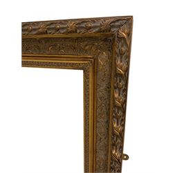 Large wall mirror in heavy swept gilt frame with floral swags, bevelled plate