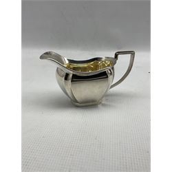 Silver sauce boat with crimped rim and loop handle Sheffield 1952 Maker Viners and a silver cream jug with gilded interior Birmingham 1932 Maker William Adams 9.5oz (2)
