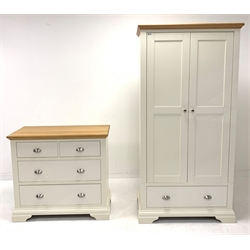 Contemporary oak and cream finish double wardrobe, with interior fitted with shelf and for hanging over one drawer, raised on shaped bracket supports, (W99cm, H195cm, D58cm) together with a matching chest fitted with two short and two long drawers, (W100cm, D90cm, D49cm)
