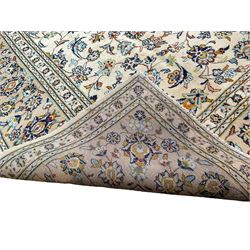 Fine Persian Nain ivory ground carpet, the large central floral pole medallion surrounded by interlacing palmettes with scrolling foliate detail, the multi-band border with repeating stylised plant motifs