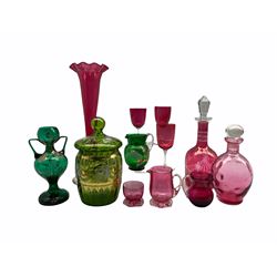 Cranberry glass trumpet shape vase H38cm, three cranberry wine glasses, cranberry carafe and decanter, other cranberry glass and three pieces of green enamelled glass (12)