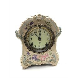 Late 19th century floral painted 'Royal Bonn' porcelain mantel clock, cartouche shaped case moulded with scrolled foliage, circular Arabic enamel dial with the 'Ansonia' trademark, twin train 'Ansonia' movement striking the hours and half on single coil, Royal Bonn mark on case reverse, with pendulum and key, H26cm W22cm