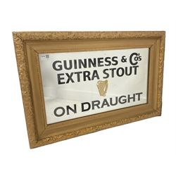 20th century wall hanging mirror, the floral carved gilt frame enclosing mirrored plate reading 'Guinness & Co's Extra Stout on Draught' 75cm x 49cm