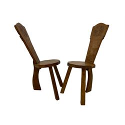 'Gnomeman' pair oak hall chairs, the shaped back carved with flower head motif and carved with gnome signature, on three supports, the seat, back and rear support adzed, by Thomas Whittaker of Little Beck, Whitby 