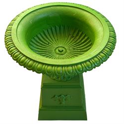 20th century green painted cast iron urn on stand, egg and dart moulded rim over gadrooned underbelly and moulded footed base, on a tapered square base decorated with floral urns