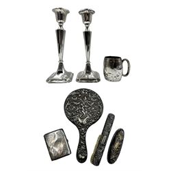 Pair of silver candlesticks with tapering stems H20cm Birmingham 1917, small silver christening mug with loop handle H6.5cm, silver cigarette case and three pieces from a silver dressing table set, weighable silver 3.8oz