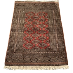 Persian Bokhara design rug, field decorated with Guls, multiple border with geometric motifs, 186cm x 128cm