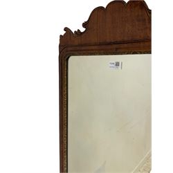 George III mahogany framed wall mirror, the shaped pediment over moulded frame with gilt and foliate carved inner slip, bevelled mirror plate