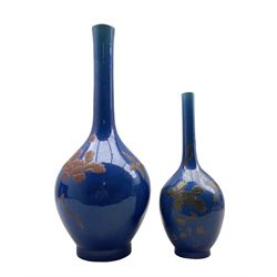 Pair of graduated Chinese blue glazed bottle vases, each decorated in relief with birds, insects and flowers, maximum H58cm (one a/f)