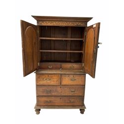 Anglo-Indian teak cupboard on chest, moulded cornice over frieze with floral marquetry and two doors with arched mirrors enclosing two shelves and two drawers, two short and two long drawers to base, raised on bun supports 