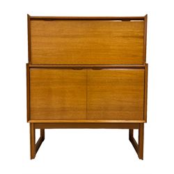Turnidge of London - mid-20th century teak drinks cabinet, top section with fall-front enclosing mirror backed drinks area with shelf, bottom section with two cupboard doors concealing bottle rack and shelf, raised on shaped supports