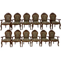 Set twelve French style cherry wood dining elbow chairs, pierced pediments decorated with flower heads and c-scrolls, upholstered in floral pattern fabric, cabriole supports carved with flower heads