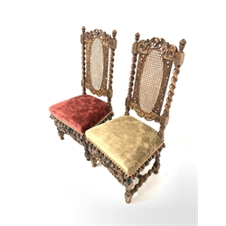 Pair of 19th century Carolean style walnut chairs, spiral turned uprights enclosing oval cane panels to the back rest, floral tassled velvet upholstered seat, raised on spiral turned supports and stretchers, profusely carved throughout with cherubs, eagles and floral scrolls  
